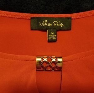 women's orange blouse with gold hardware